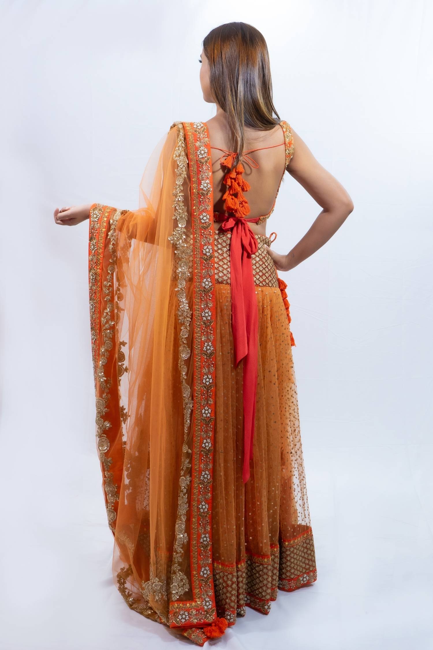 Orange and gold detail lengha Indian outfit rental in Bangkok