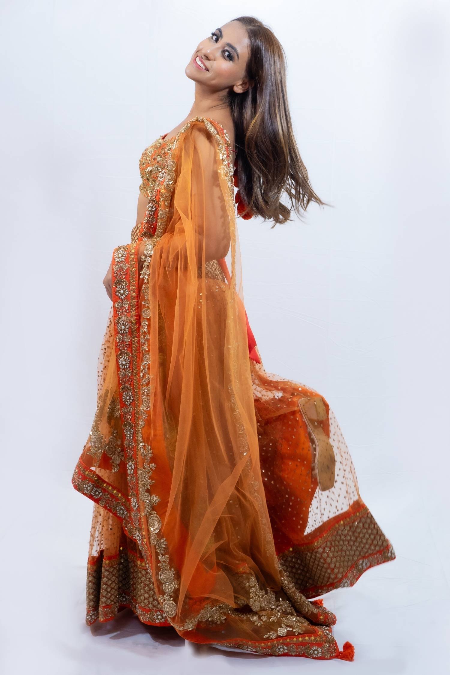 Orange and gold detail lengha Indian outfit rental in Bangkok